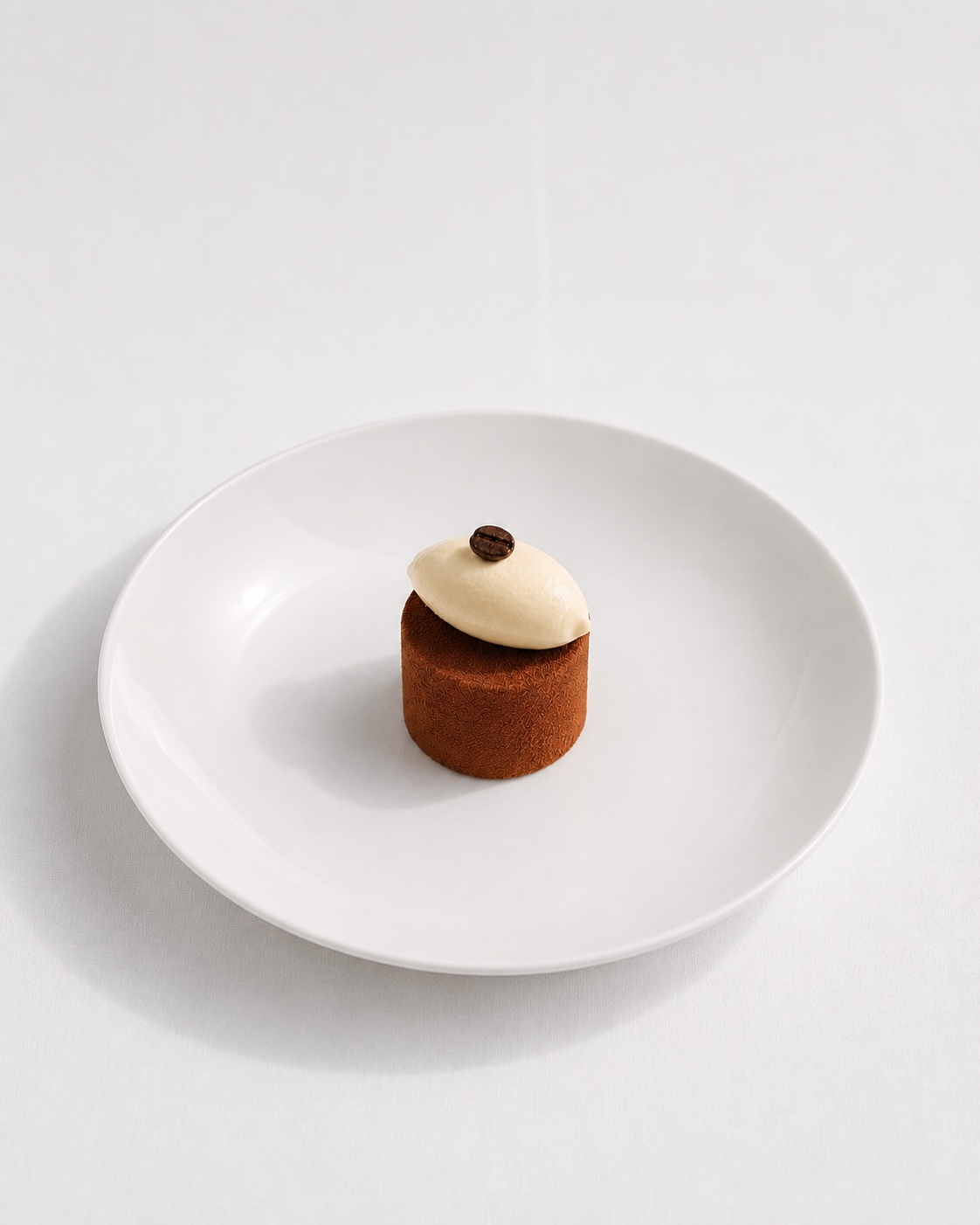 A tiramisu dessert against roasted coffee beans.